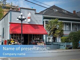 A Blue Building With A Red Awning On A Street Corner PowerPoint Template