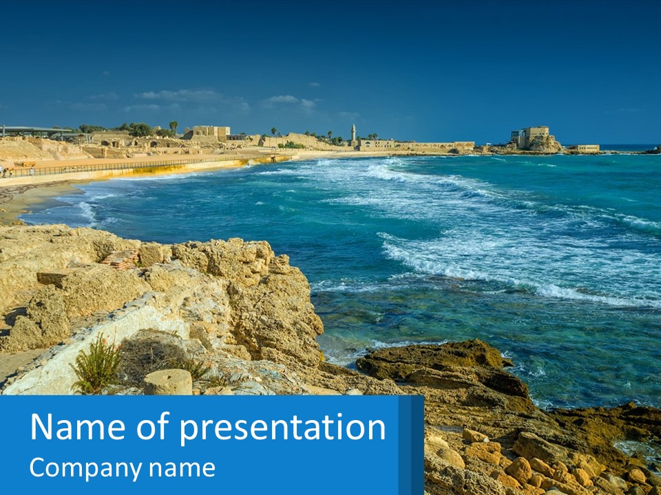 A Rocky Beach With A Body Of Water In The Background PowerPoint Template