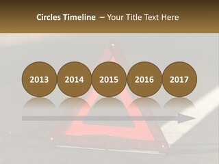 A Red Triangle Sign Sitting On The Side Of A Road PowerPoint Template