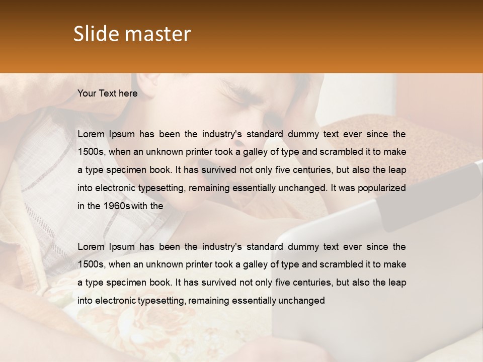 A Young Boy Laying In Bed Using A Laptop Computer PowerPoint Template