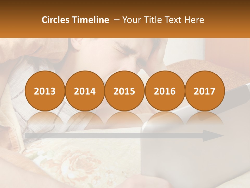 A Young Boy Laying In Bed Using A Laptop Computer PowerPoint Template