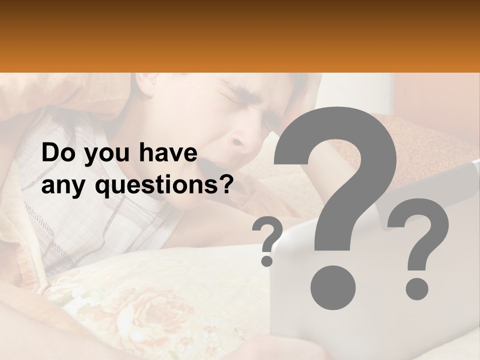 A Young Boy Laying In Bed Using A Laptop Computer PowerPoint Template