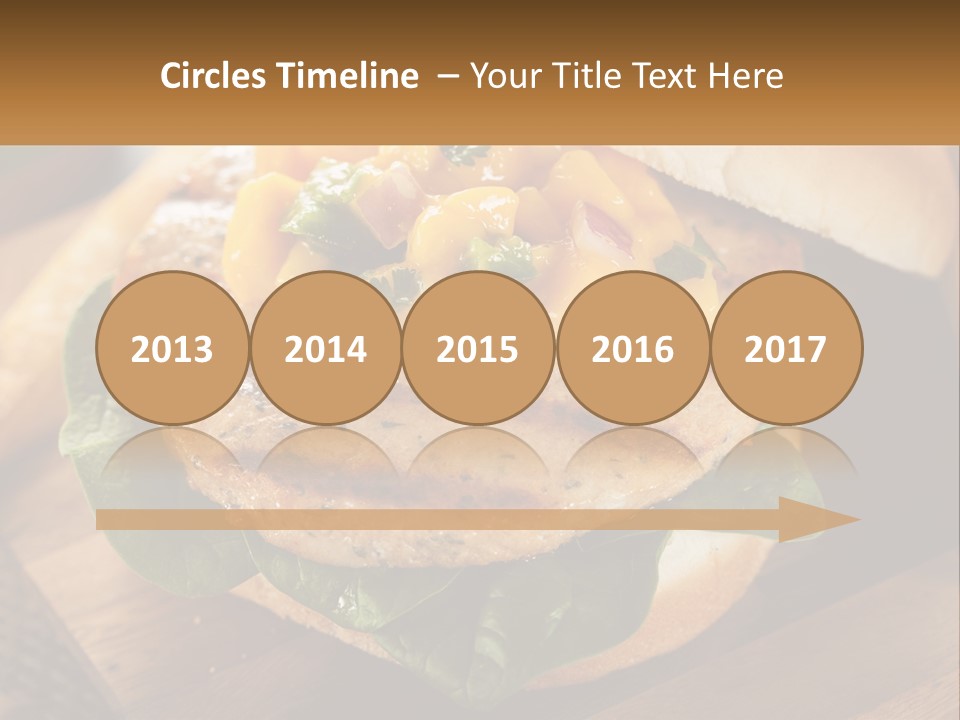 A Chicken Sandwich With Cheese And Lettuce On A Wooden Cutting Board PowerPoint Template