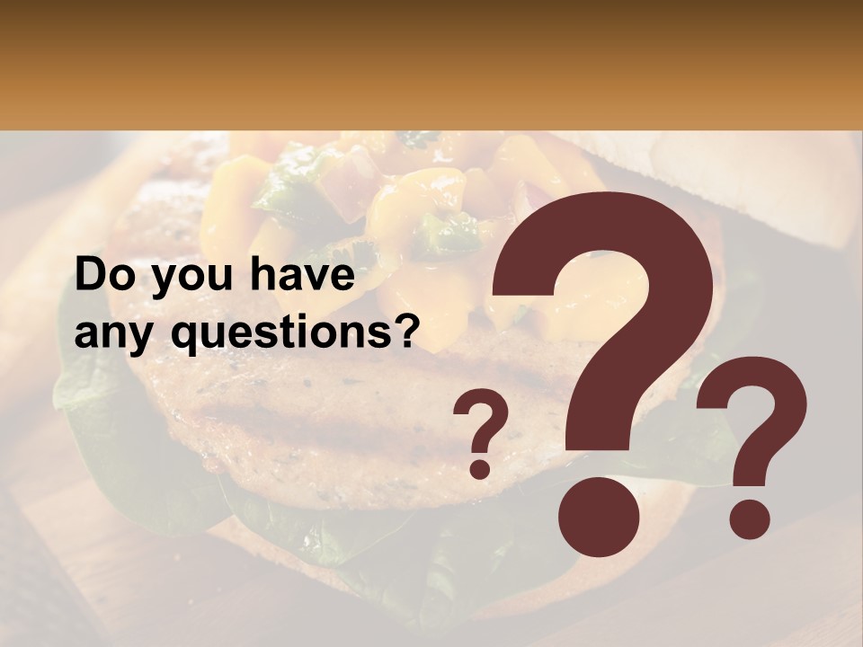 A Chicken Sandwich With Cheese And Lettuce On A Wooden Cutting Board PowerPoint Template