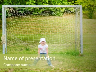 A Young Boy Standing In Front Of A Soccer Goal PowerPoint Template