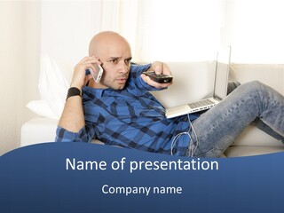A Man Sitting On A Couch Talking On A Cell Phone PowerPoint Template