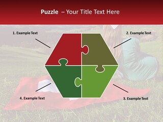 A Woman Sitting On Top Of A Blanket On Top Of A Lush Green Field PowerPoint Template