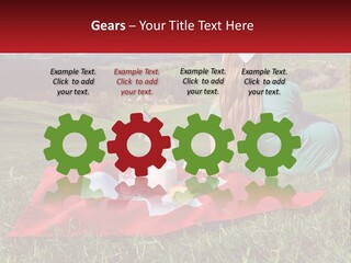 A Woman Sitting On Top Of A Blanket On Top Of A Lush Green Field PowerPoint Template