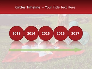 A Woman Sitting On Top Of A Blanket On Top Of A Lush Green Field PowerPoint Template