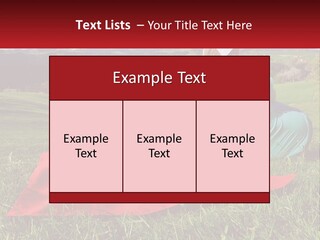 A Woman Sitting On Top Of A Blanket On Top Of A Lush Green Field PowerPoint Template