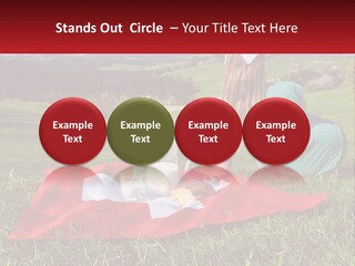 A Woman Sitting On Top Of A Blanket On Top Of A Lush Green Field PowerPoint Template