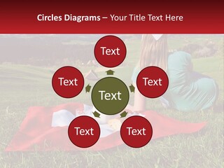 A Woman Sitting On Top Of A Blanket On Top Of A Lush Green Field PowerPoint Template
