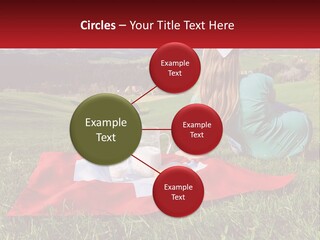 A Woman Sitting On Top Of A Blanket On Top Of A Lush Green Field PowerPoint Template