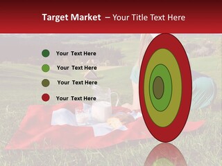 A Woman Sitting On Top Of A Blanket On Top Of A Lush Green Field PowerPoint Template