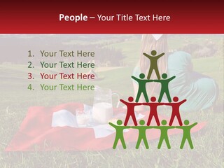 A Woman Sitting On Top Of A Blanket On Top Of A Lush Green Field PowerPoint Template