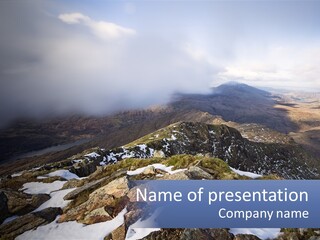 A Mountain Range Covered In Snow And Clouds PowerPoint Template
