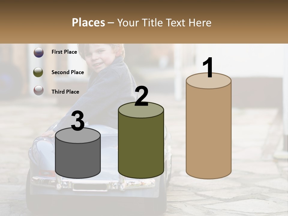 A Young Boy Is Sitting In A Toy Car PowerPoint Template