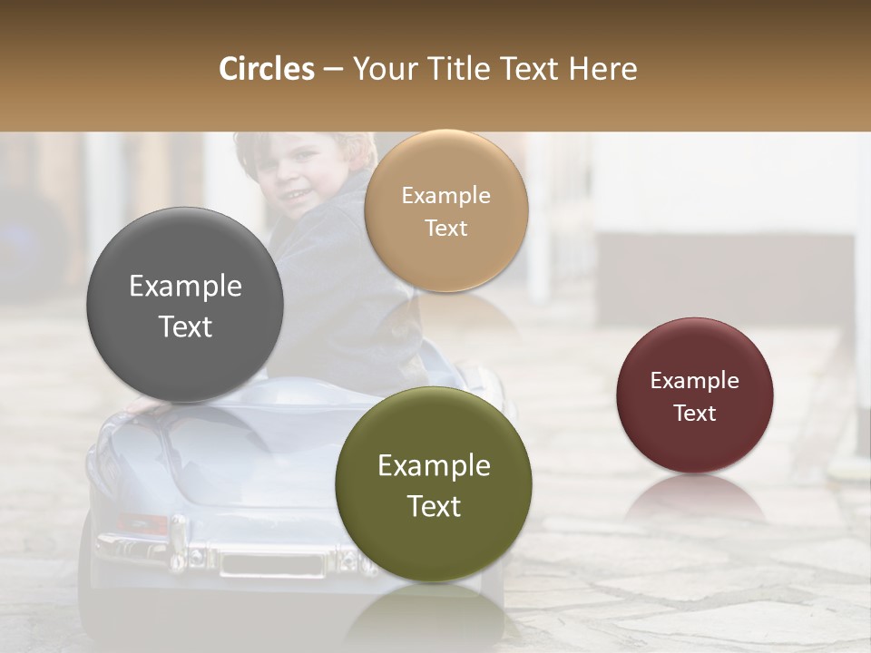 A Young Boy Is Sitting In A Toy Car PowerPoint Template