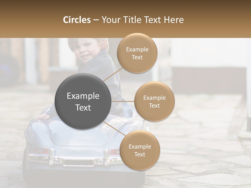 A Young Boy Is Sitting In A Toy Car PowerPoint Template