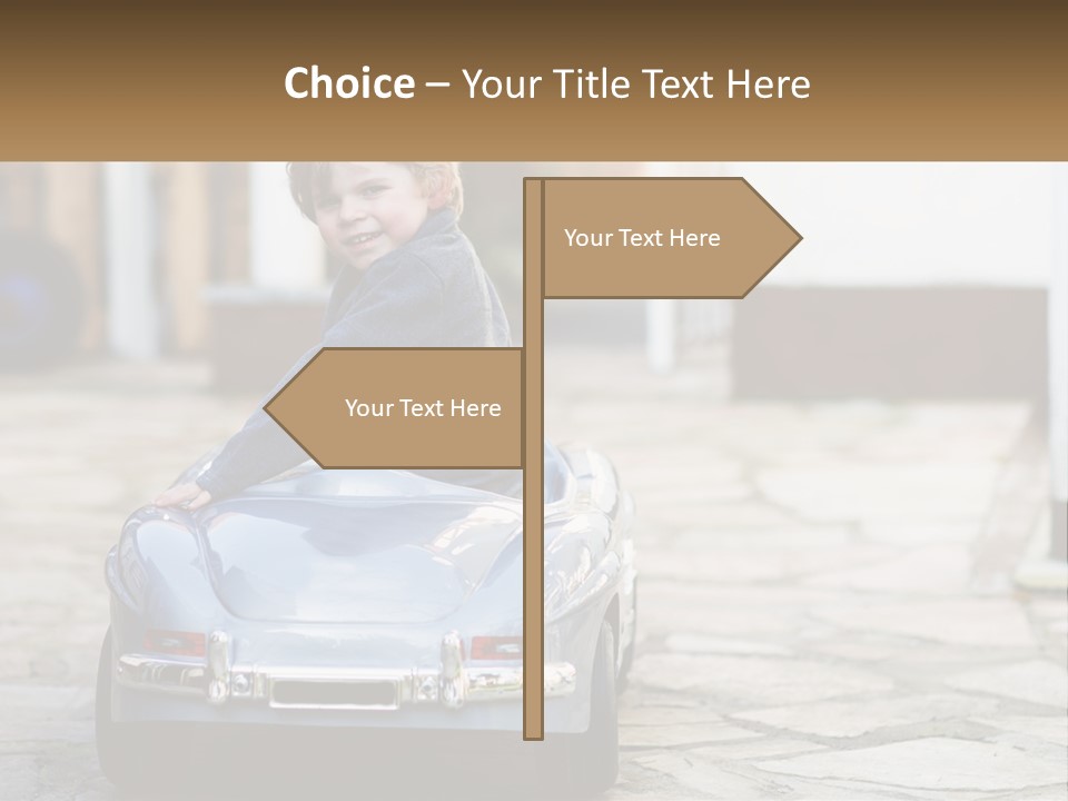A Young Boy Is Sitting In A Toy Car PowerPoint Template