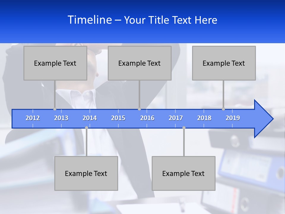 A Man Sitting At A Desk With His Head In His Hands PowerPoint Template