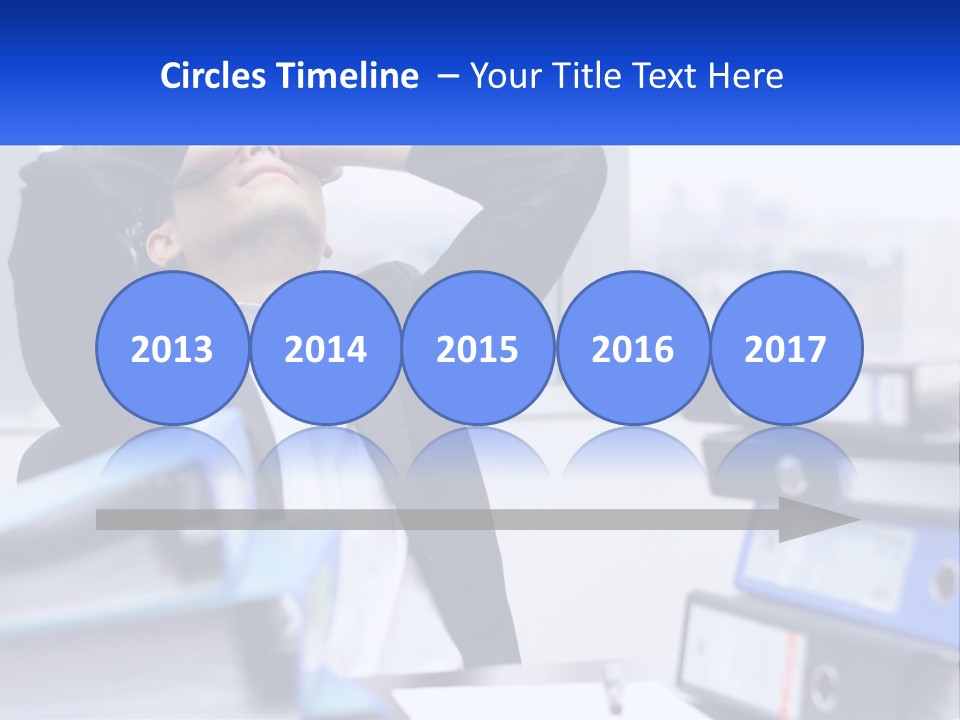 A Man Sitting At A Desk With His Head In His Hands PowerPoint Template