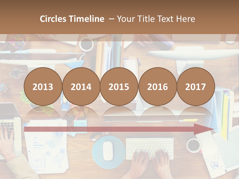 A Group Of People Sitting At A Table Working On Laptops PowerPoint Template