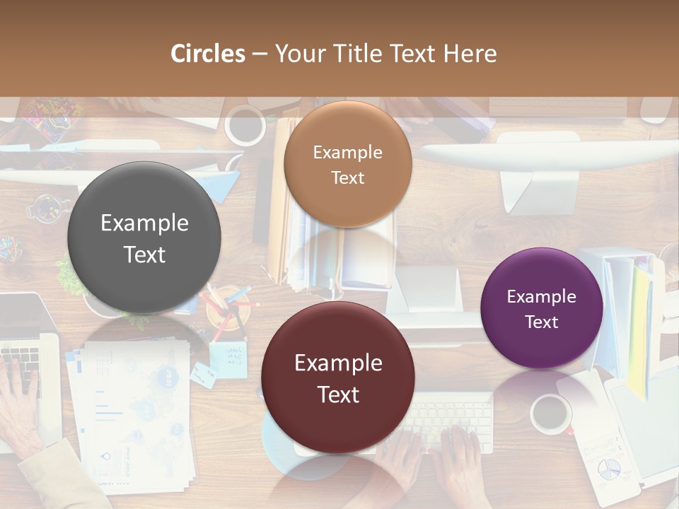 A Group Of People Sitting At A Table Working On Laptops PowerPoint Template