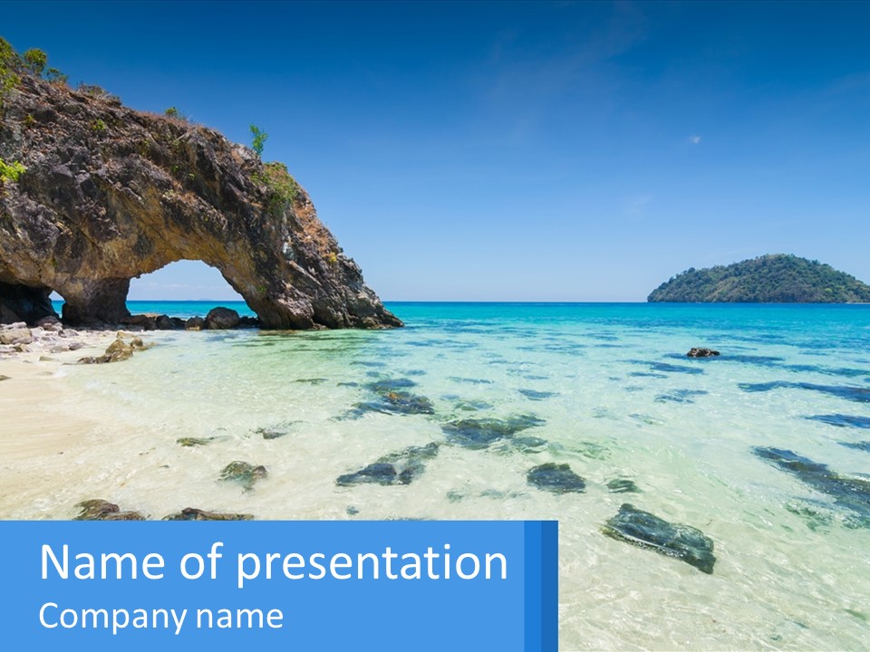 A Beach With Rocks And Clear Blue Water PowerPoint Template