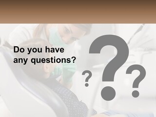 A Young Girl Getting Her Teeth Checked By A Dentist PowerPoint Template