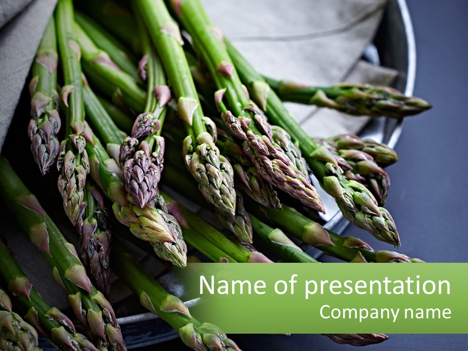 A Bunch Of Asparagus On A Plate On A Table PowerPoint Template