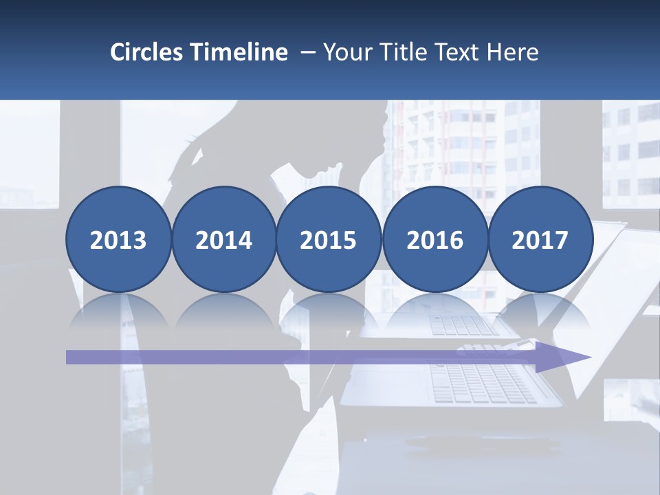 A Man Sitting In Front Of A Laptop Computer PowerPoint Template