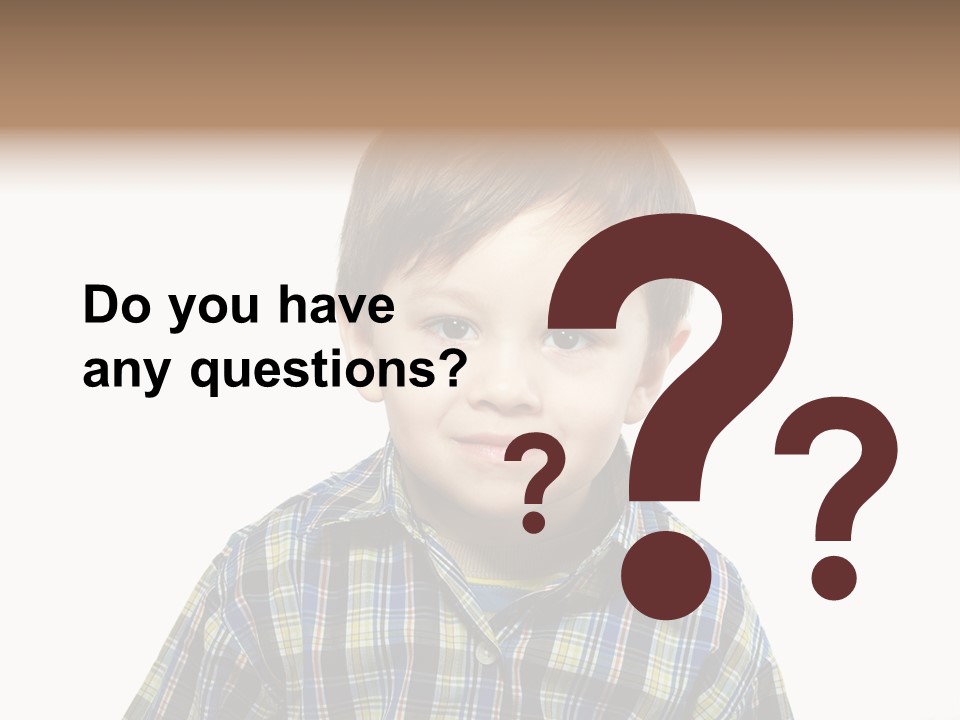 A Young Boy Is Smiling For The Camera PowerPoint Template