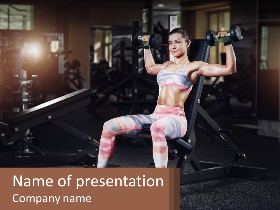 A Woman Is Doing Exercises With Dumbbells In A Gym PowerPoint Template