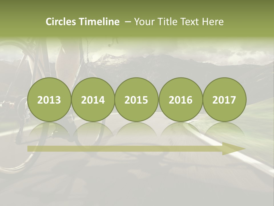 A Person Riding A Bike On A Road With Mountains In The Background PowerPoint Template