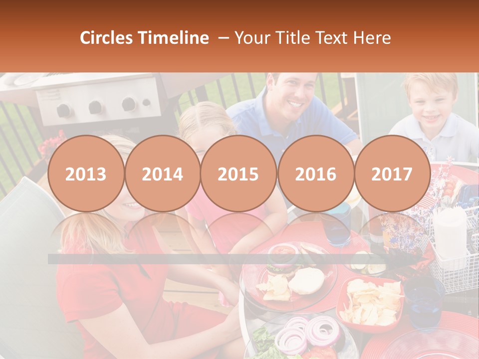 A Group Of People Sitting Around A Table With Food PowerPoint Template