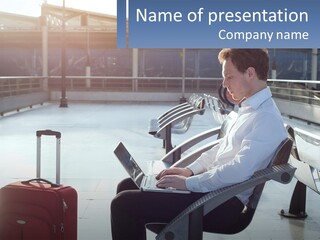 A Man Sitting On A Bench With A Laptop PowerPoint Template