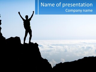 A Person Standing On Top Of A Mountain With Their Arms In The Air PowerPoint Template