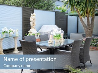 A Table And Chairs On A Patio With A Statue In The Background PowerPoint Template