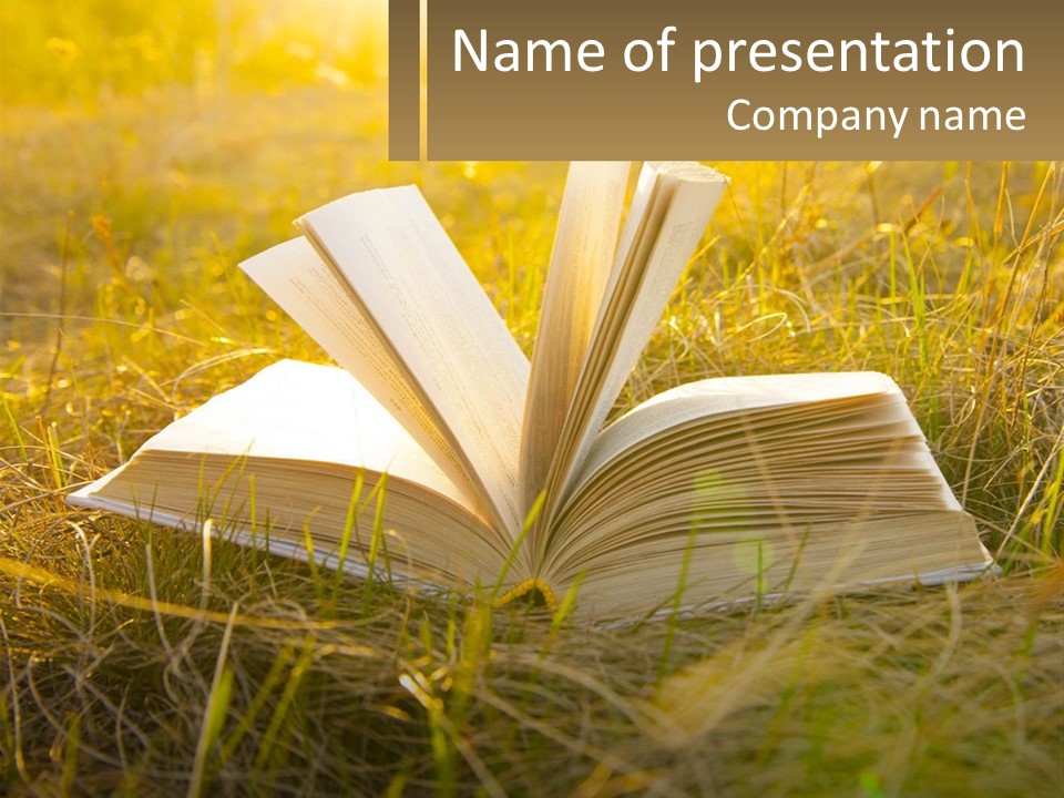 An Open Book Sitting On Top Of A Lush Green Field PowerPoint Template