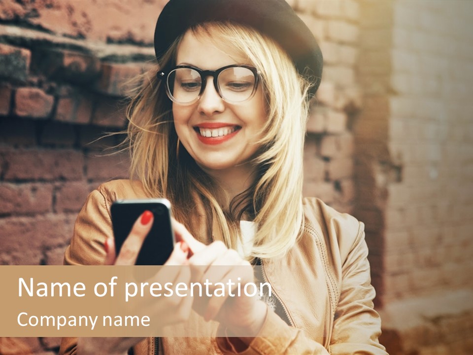 A Woman Wearing Glasses And A Hat Is Looking At Her Cell Phone PowerPoint Template