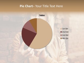 A Woman Wearing Glasses And A Hat Is Looking At Her Cell Phone PowerPoint Template