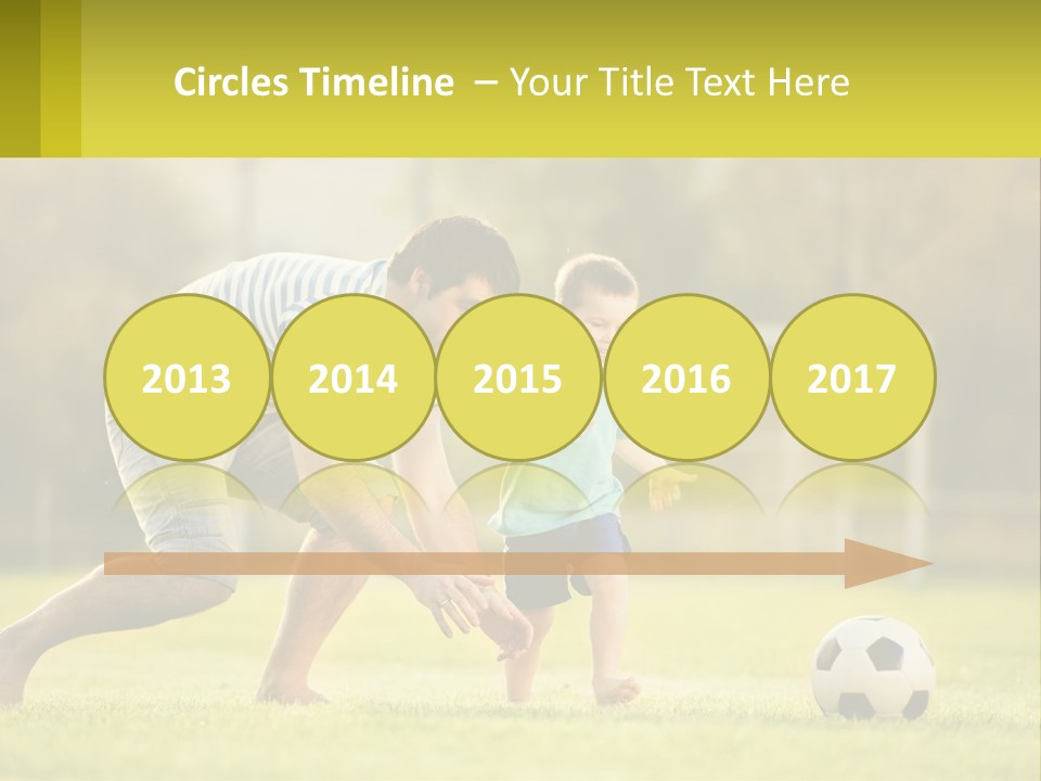 A Father And Son Playing Soccer On A Field PowerPoint Template