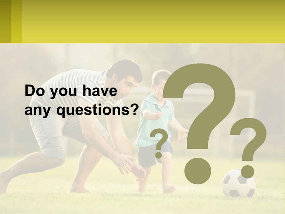 A Father And Son Playing Soccer On A Field PowerPoint Template