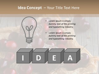 A Piece Of Cake With Cherries And A Cup Of Tea On A Wooden Table PowerPoint Template