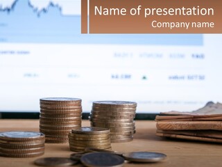 A Pile Of Coins Sitting On Top Of A Wooden Table PowerPoint Template
