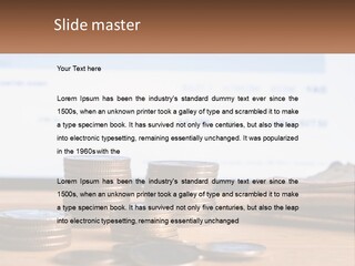 A Pile Of Coins Sitting On Top Of A Wooden Table PowerPoint Template