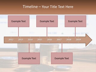 A Pile Of Coins Sitting On Top Of A Wooden Table PowerPoint Template