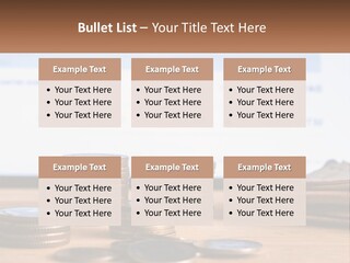 A Pile Of Coins Sitting On Top Of A Wooden Table PowerPoint Template