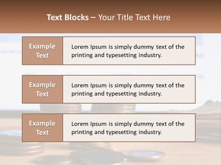 A Pile Of Coins Sitting On Top Of A Wooden Table PowerPoint Template
